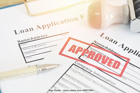 Application documents for credit with red stamp "Approved"