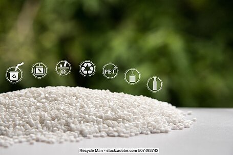 Small heap of white PET pellets on a white surface.