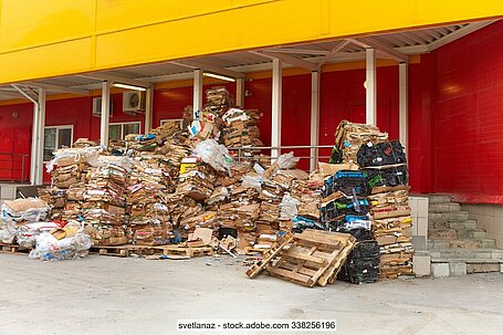 OCC and other paper and board packaging stacked behind a supermarket