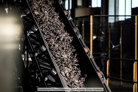Shredded end-of-life tyres on a conveyer