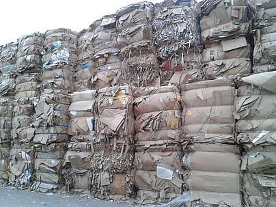 stacked bales of recovered paper