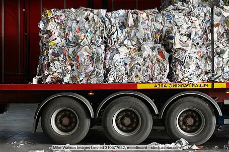 Side view of a heavy goods vehicle (HGV) loaded with recovered paper bales.