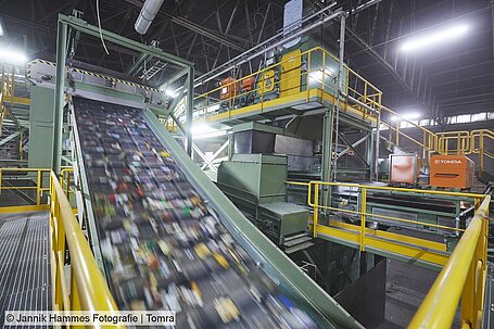 Packaging waste travels along a conveyor in a sorting pant