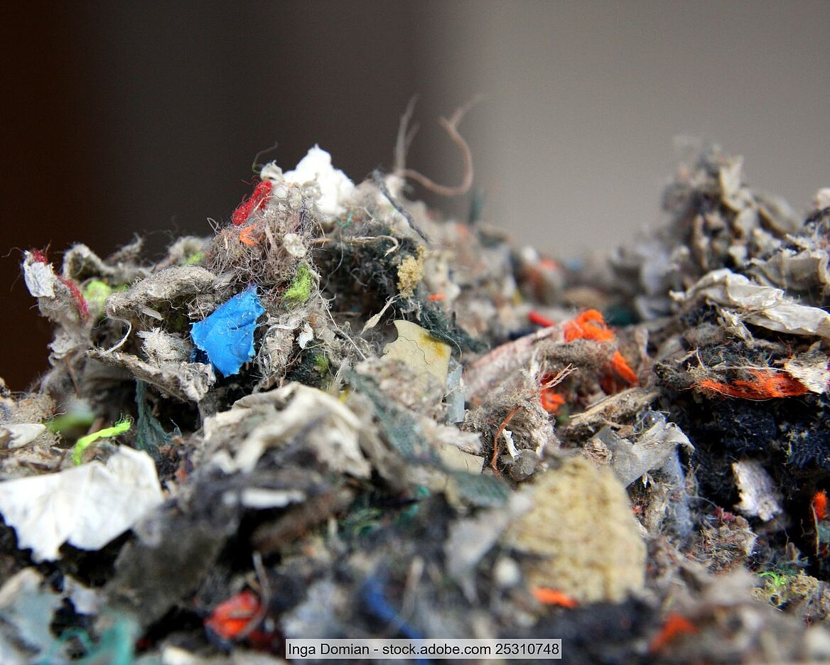 Close-up of refuse-derived fuel (RDF) consisting of small pieces of textile fibre, foam, plastic and paper material