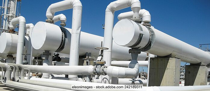 Stock photo showing white pipes on an industrial site