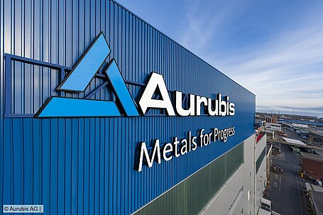Aurubis logo on the outside of an industrial building.