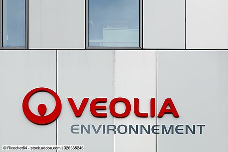 Building façade with the red Veolia logo and lettering 