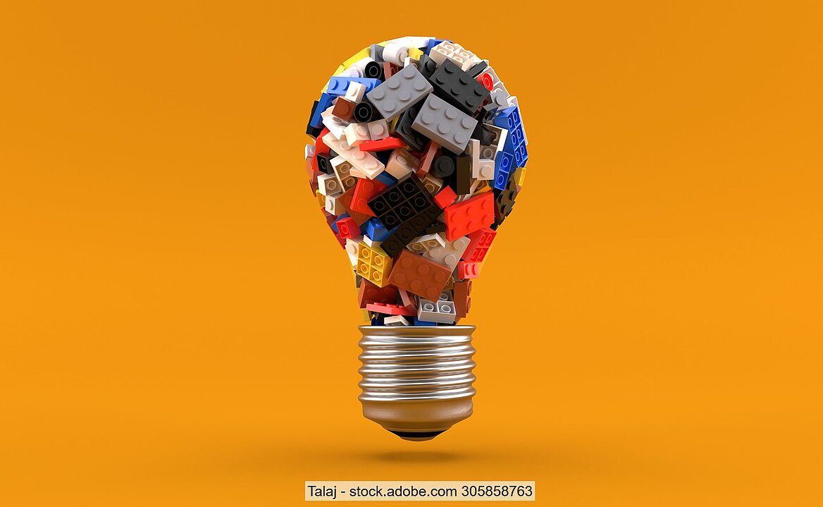 Lego bricks in light bulb against orange background