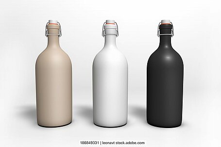 Three ceramic bottles in different colors against a white background.