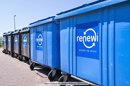 Row of grey and blue large waste bins with the Renewi logo and the words "Waste no More".