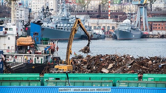 Scrap is loaded on a ship in Vladivostok using a grabber arm