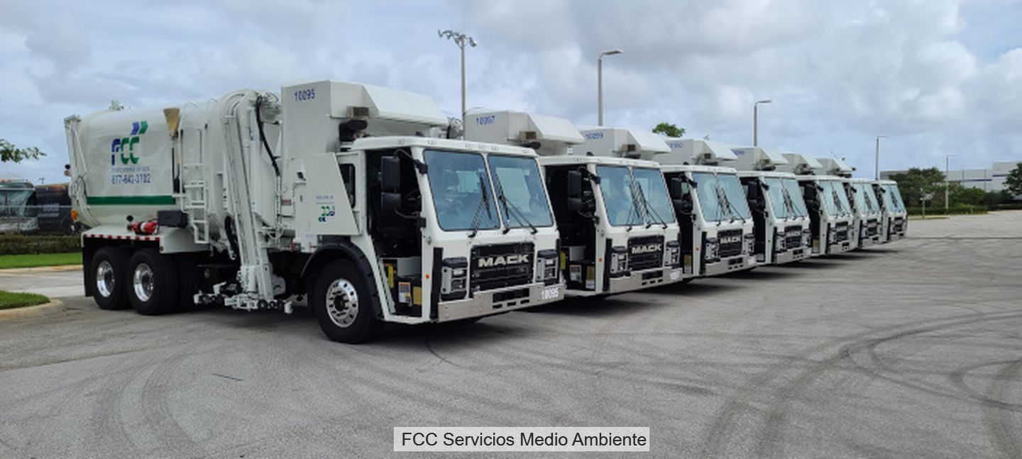 A row of parked waste collection vehicles
