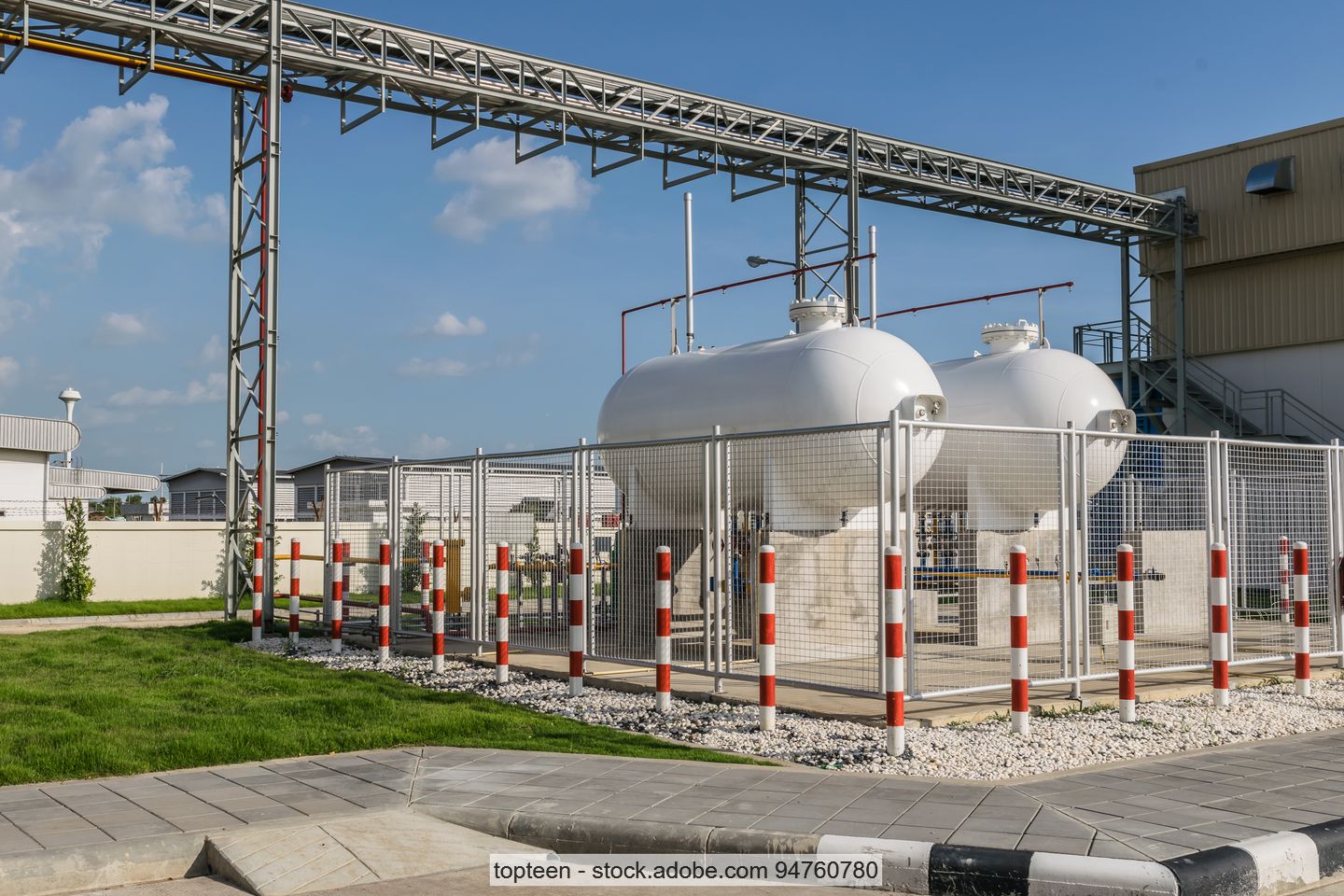 Stock photo: LPG cylinder tank isolated in safety zone inside a fence