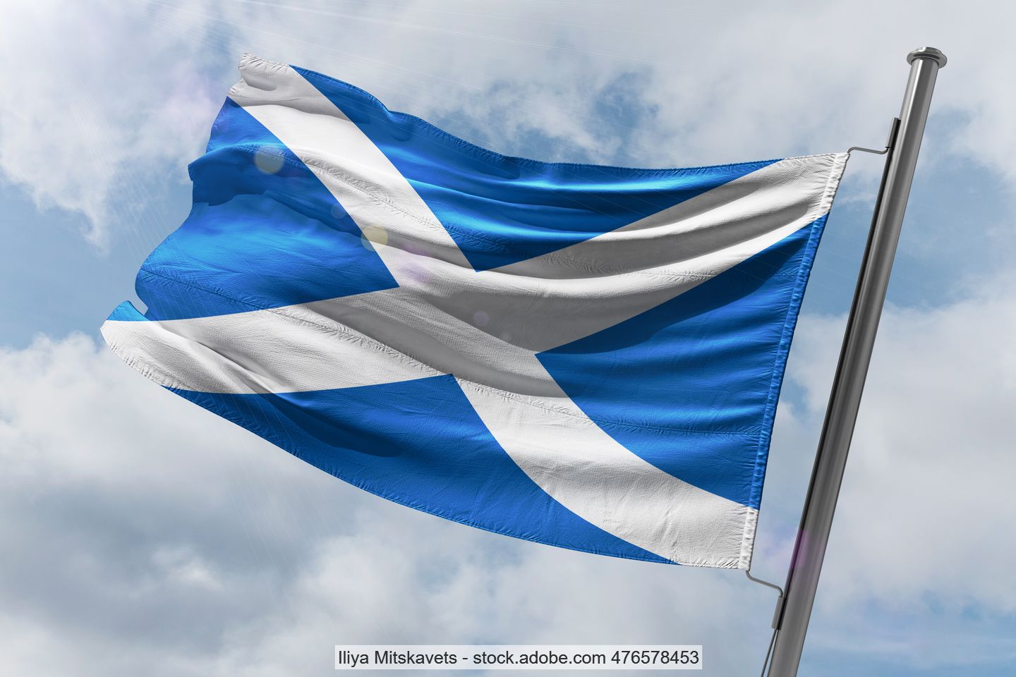 Scottish blue and white flag on a staff blowing in the wind.