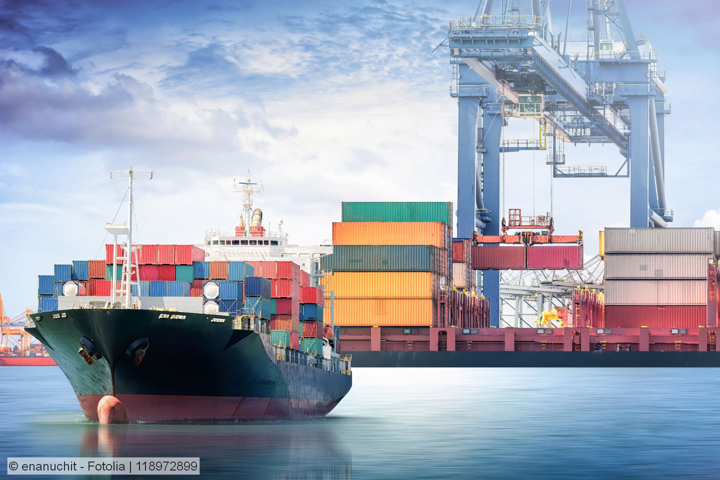 Stock photo of a container ship leaving a port
