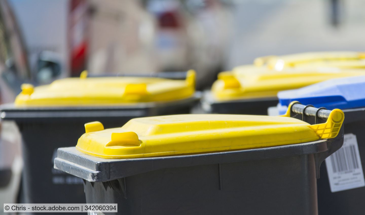 Several packaging waste bins with yellow lids