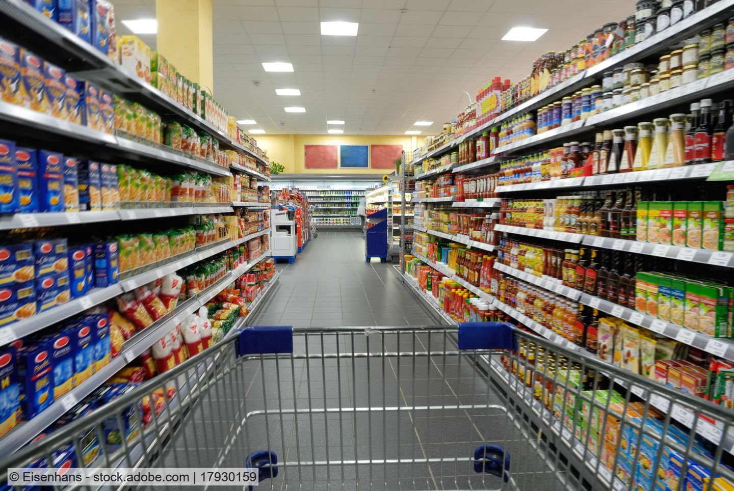grocery store aisle with full shelves (stock photo)