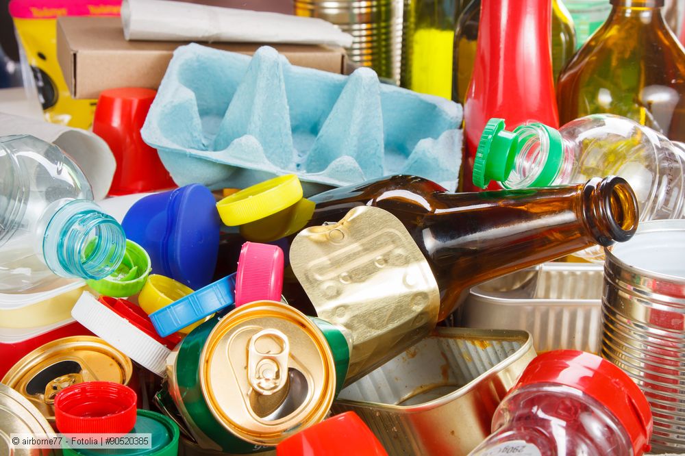 Different types of waste household packaging: egg cartons, beverage cans, plastic bottles, tin cans
