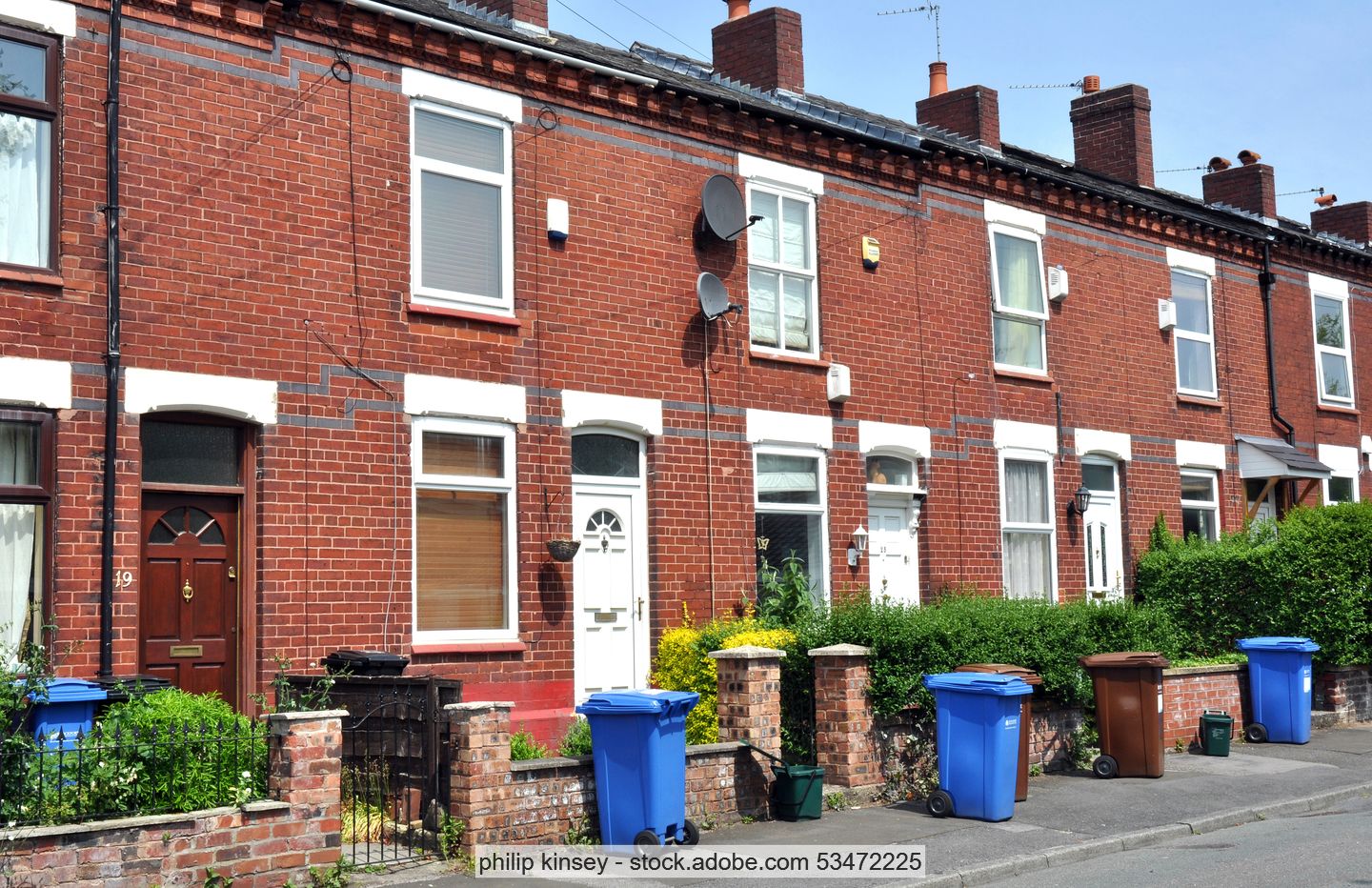 Recycling bins in front of English terraced houses