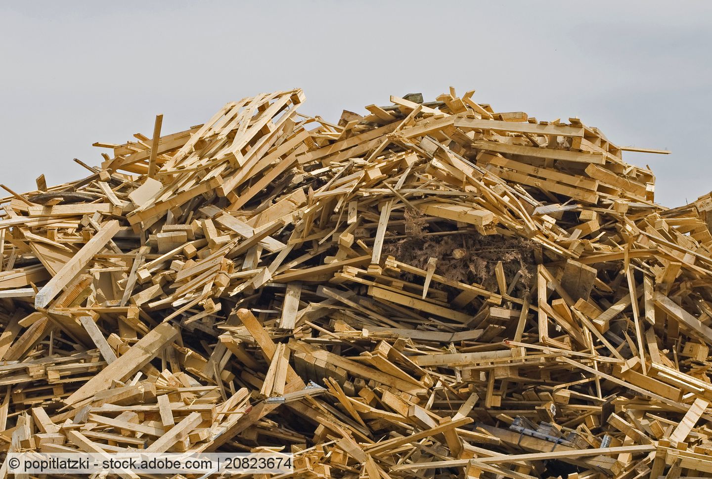 A heap of waste wood stored in a yard.