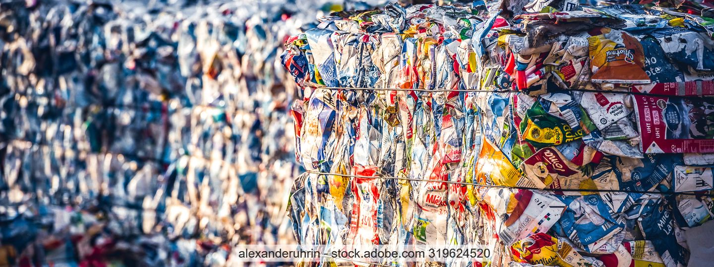 Stacked bales of plastic waste in mixed colours