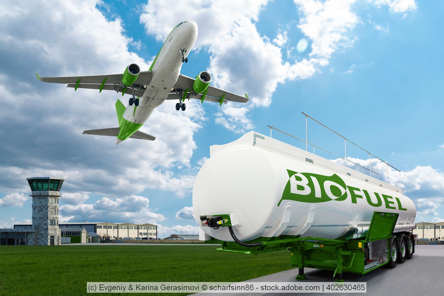 EA tank of biofuel stands at an airport and airplane flies above