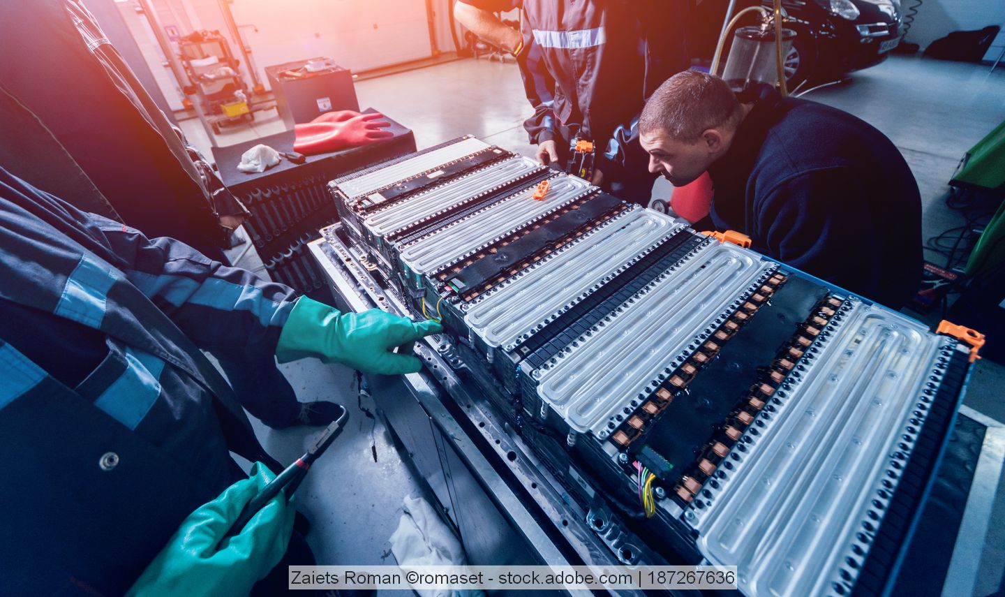 A battery pack is processed by two employees. stock image