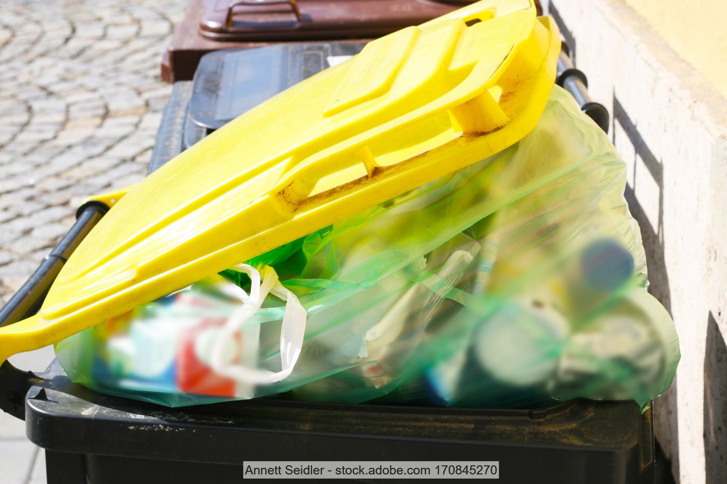 Yellow packaging waste bin overflows