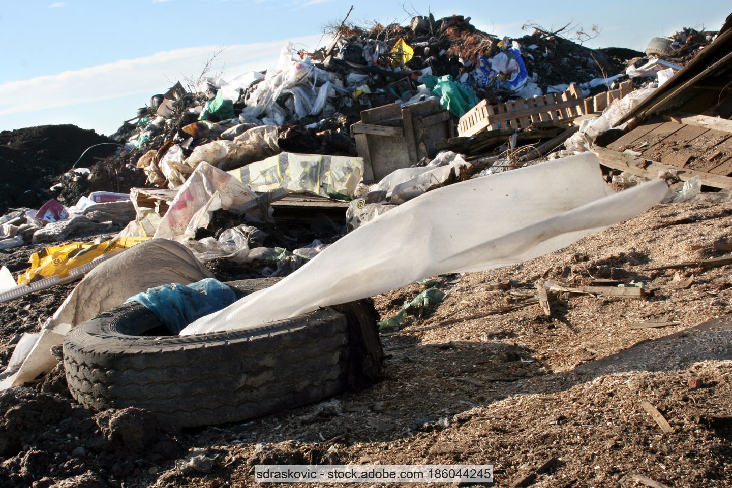 Stock photo of illegally dumped waste including scrap tyres and plastic film.
