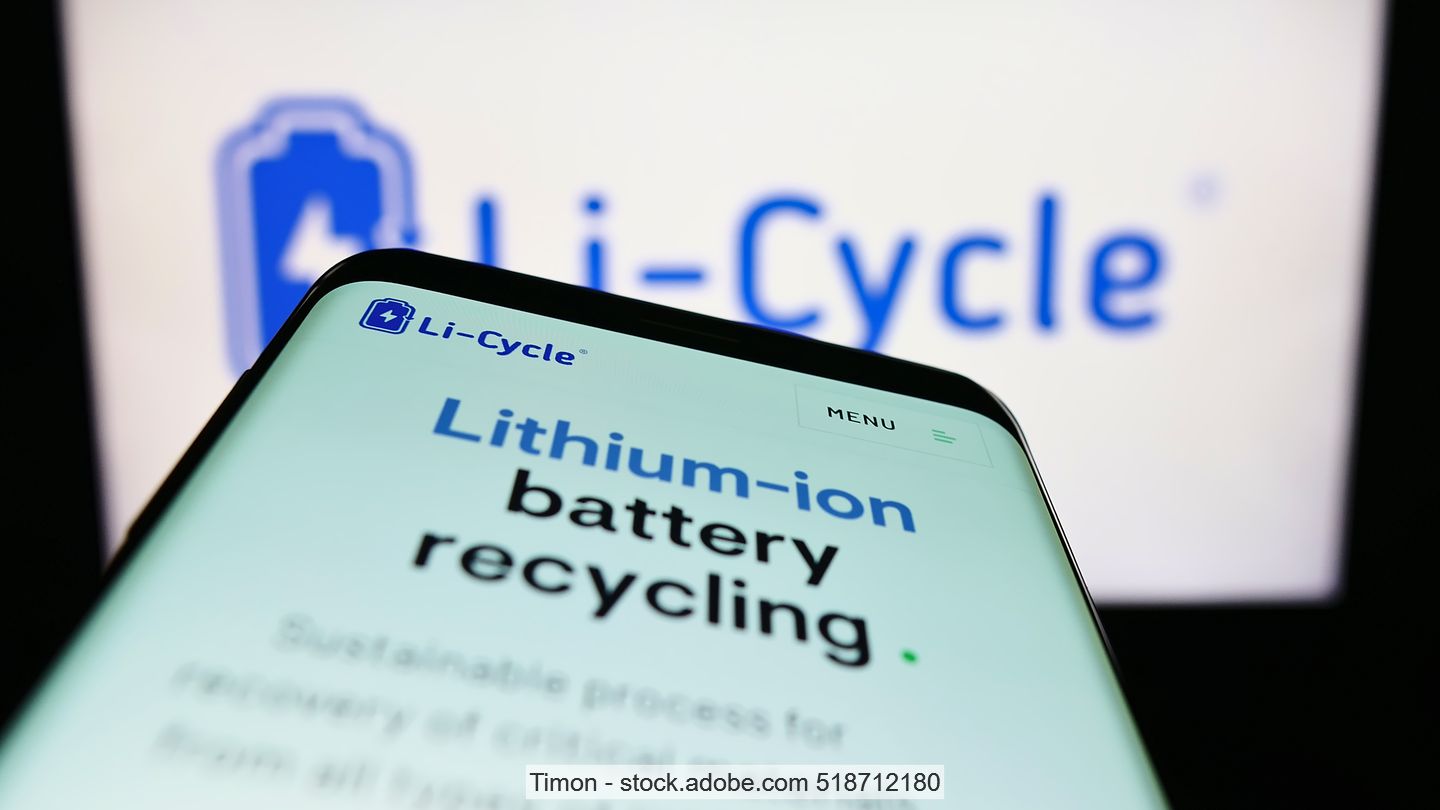 Cell phone with text "lithium-ion battery recycling" is held in front of a computer screen with the Li-Cycle logo on it