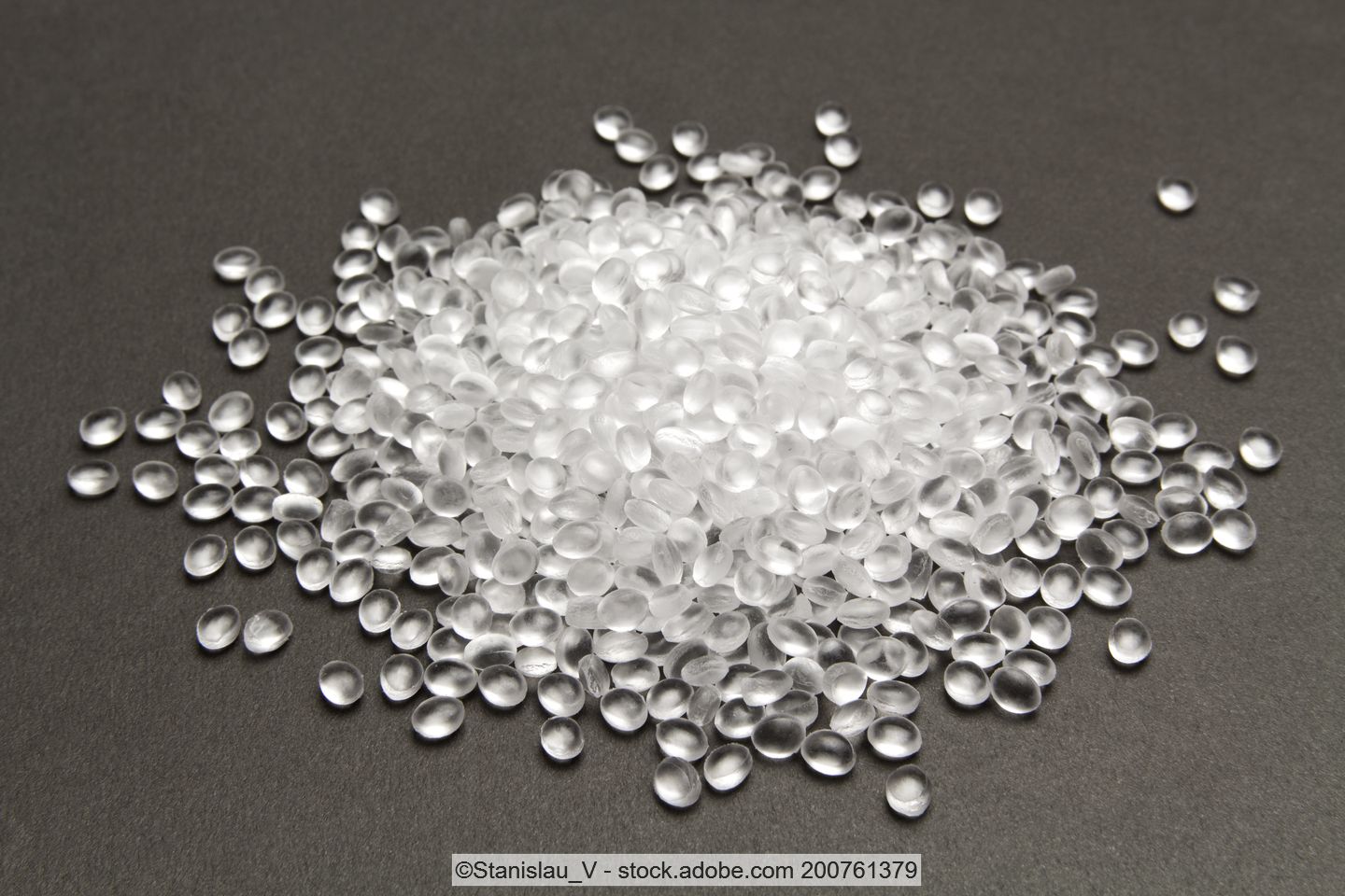 Transparent plastic pellets on a dark surface
